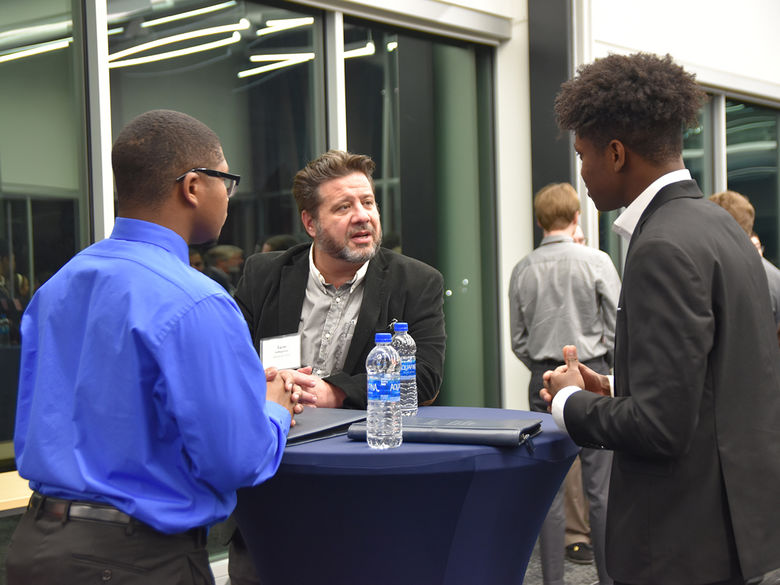 Two students having a discussion at a networking event.