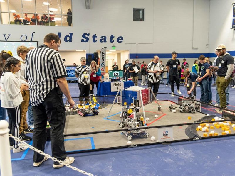 Students and adults sompete in a robotics competition
