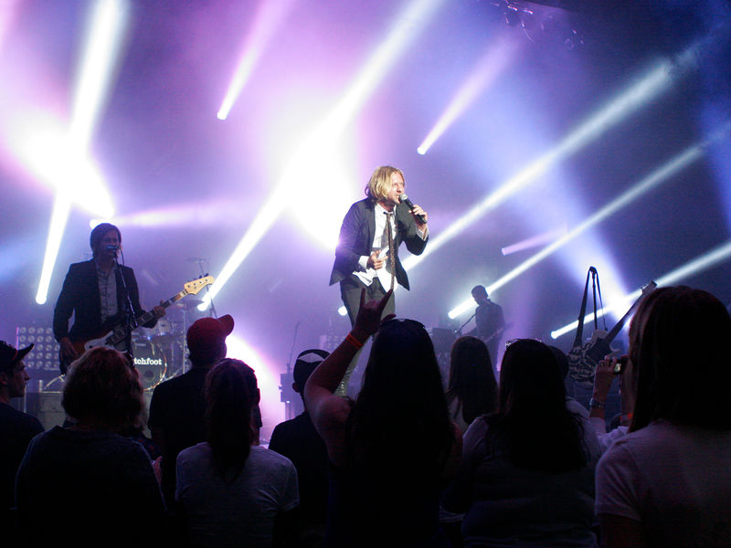 A musician singing on the stage of the Pullo Center