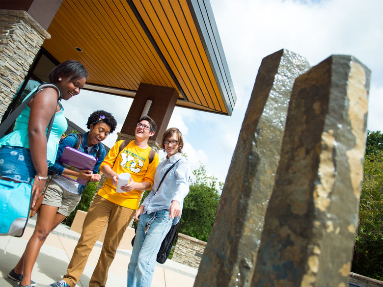 Students by the fountain outside the John J. Romano Administration Building.