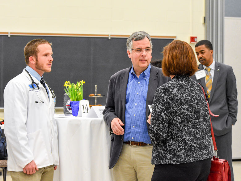 Alumni and staff chat during a Career Networking event.