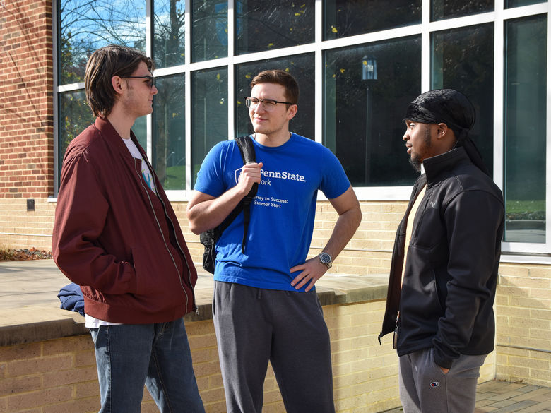 Students hanging out and talking on campus.