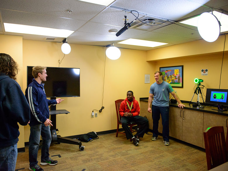 Students working in the One-Button Studio recording video