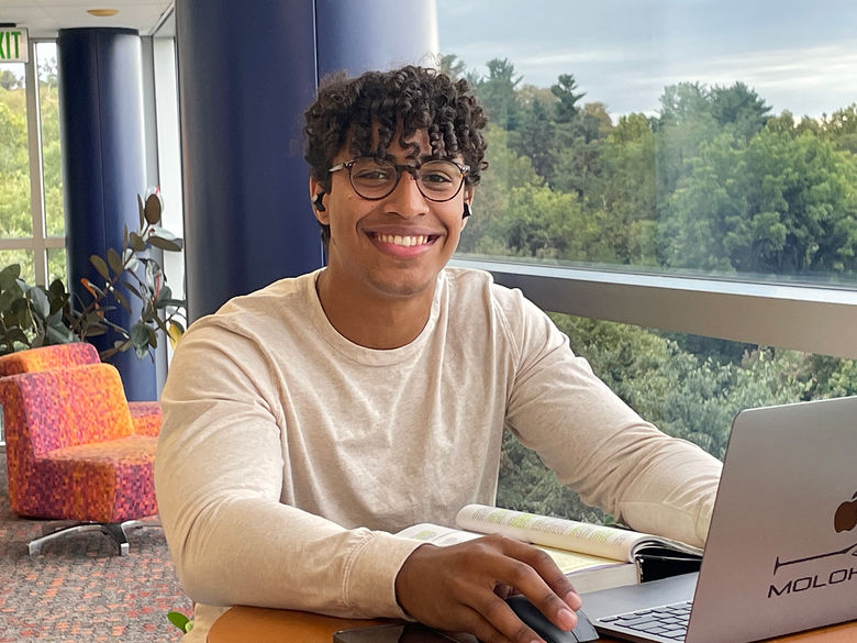 Student studying on the upper level of the Pullo Center.