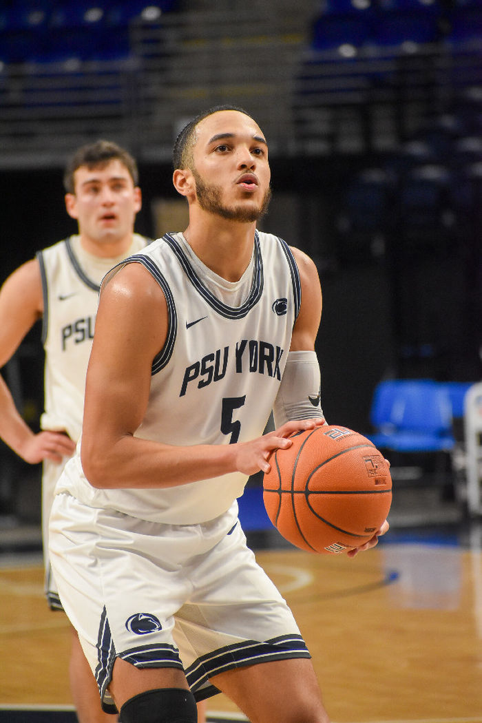 Basketball player getting ready to take a foul shot.