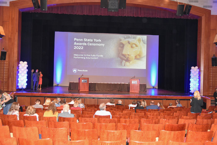 Theatre stage with podiums and balloons.