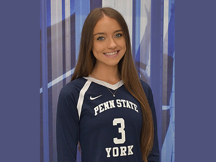 Female volleyball player with long dark hair wearing No. 3 jersey.