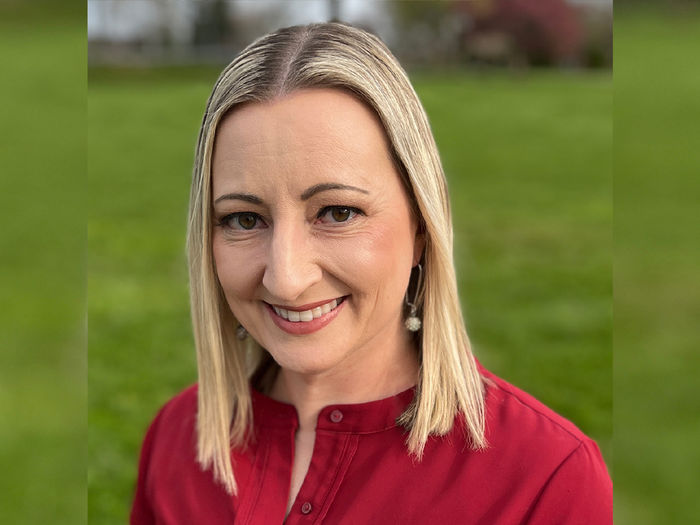 Women with shoulder-length blonde hair wearing a red blouse.