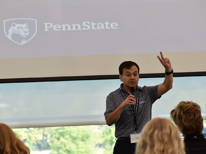 Man lecturing to a group of students.