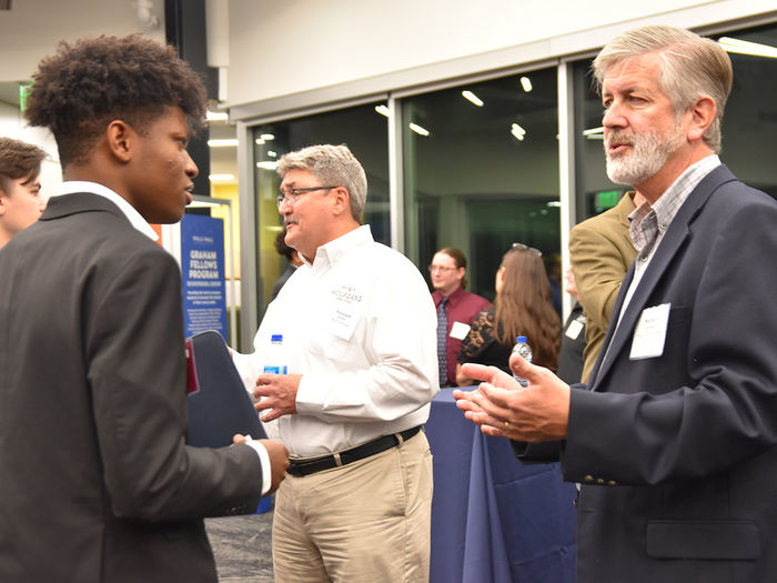 A Graham candidate conversing with a Corporate Partner of the Graham Fellows Program during an annual networking event.