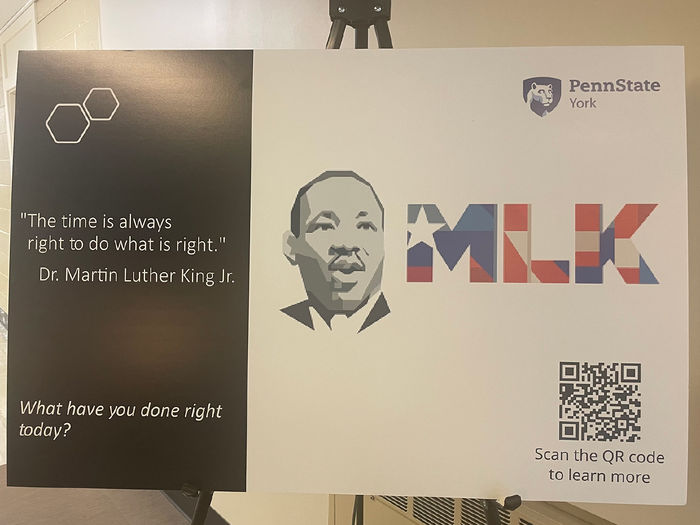 Poster featuring photo of Martin Luther King Jr. displayed on an easel
