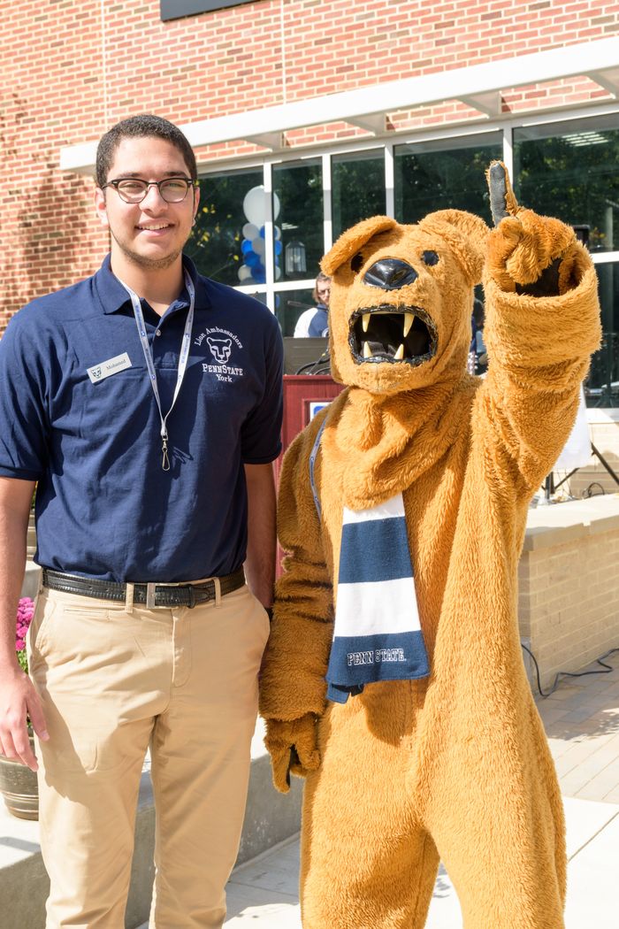 Mohamed El Sonbaty standing with the Nittany Lion mascot.