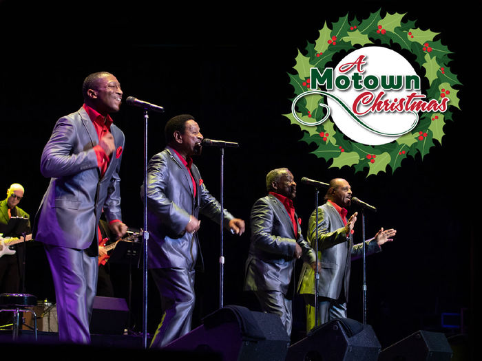 Four singers performing at microphones with the words A Motown Christmas
