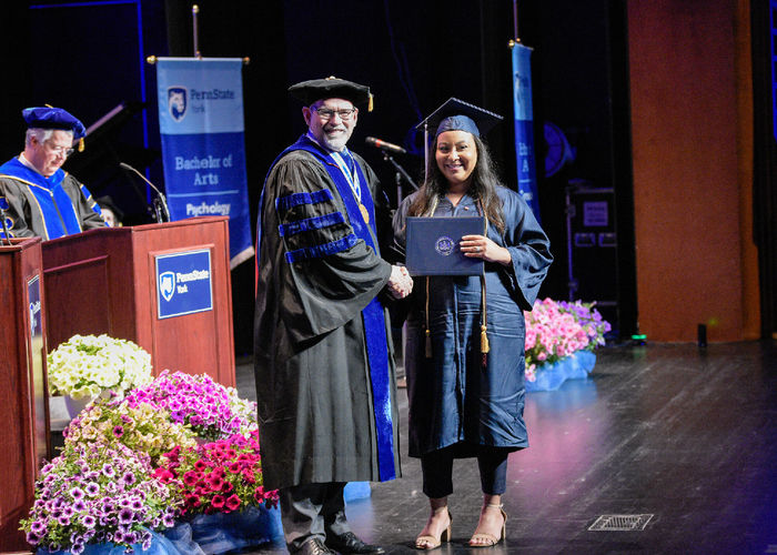 Chancellor David Christiansen congratulates Nathalie Cabrera at commencement