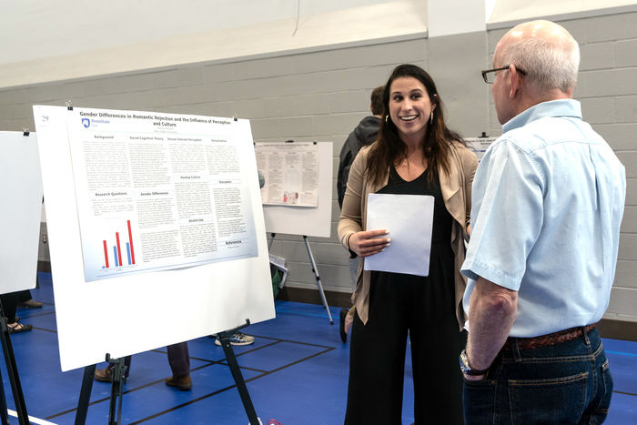 Student presenting research at the 2019 Exhibition of Undergraduate Research and Creative Accomplishments
