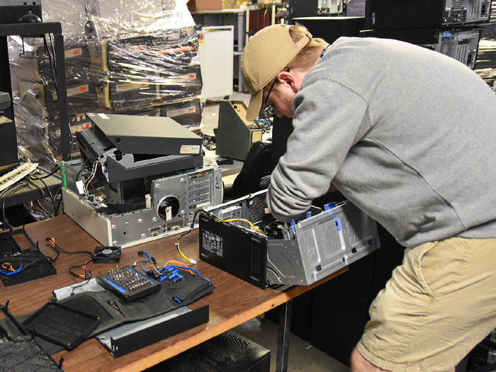 Caucasian male student working on computer equipment