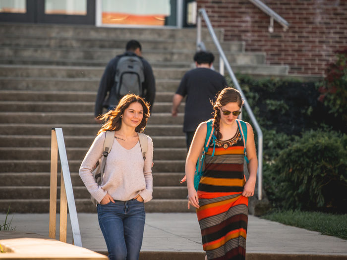 Students walking down the steps behind the John J. Romano Administration Building.