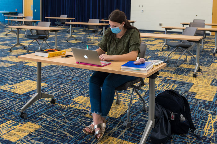 A student studying in the Conference Center Remote Learning Room.