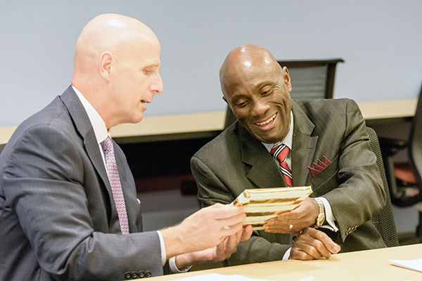 John Sygielski gives Francis Achampong a HACC picture frame as a gift.