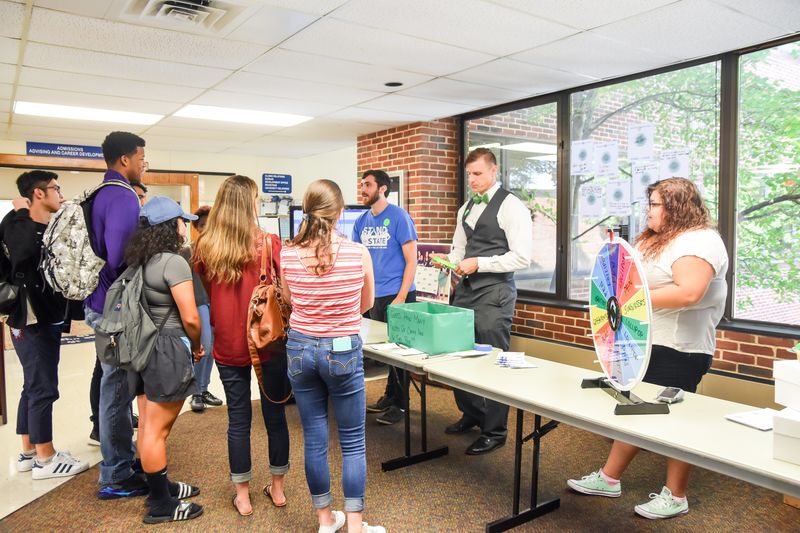 Students and staff gather at a Stand for State promotional event.