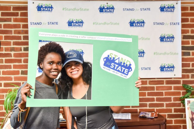 Students pose with Stand for State materials.