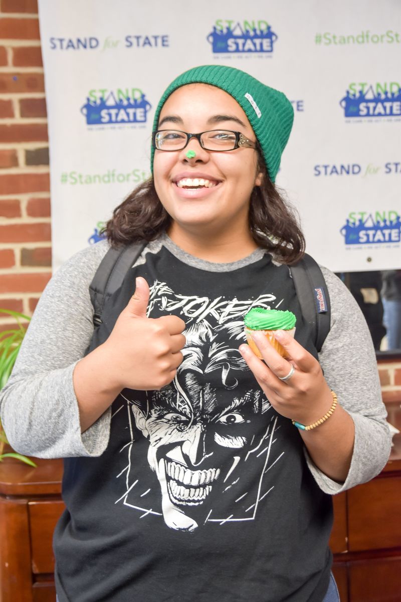 A student with a green cupcake during a Stand for State event.