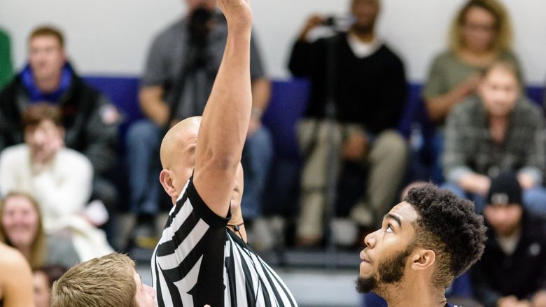 Penn State York Men’s Basketball player jumping at tip-off