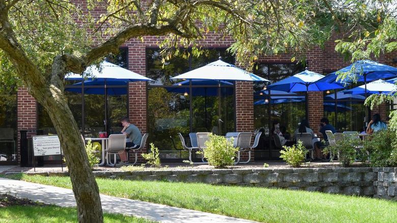 Brick outdoor patio with tables and umbrellas