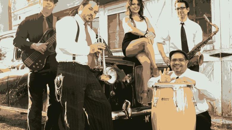 Outdoor group shot of musicians, Los Monstros, with their instruments