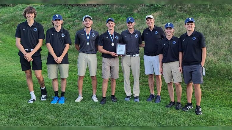 Golf team and coaches (eight males) show off the first-place trophy Penn State York won