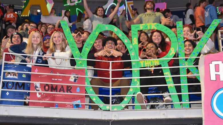 Crowd of male and female students holind large letters to spell the word YORK