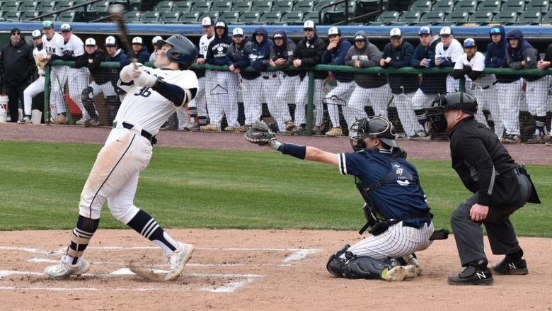 Baseball player swinging a bat.