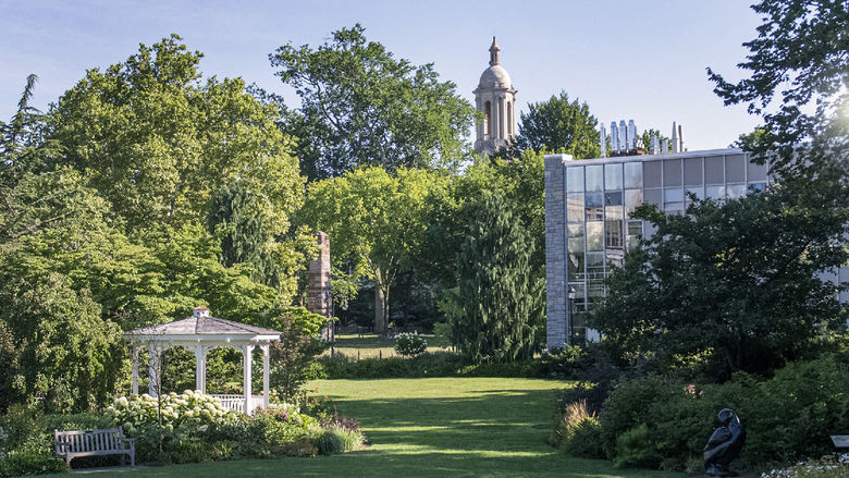 Hintz Family Alumni Center lawn on a sunny day with the Old Main bell tower in the background