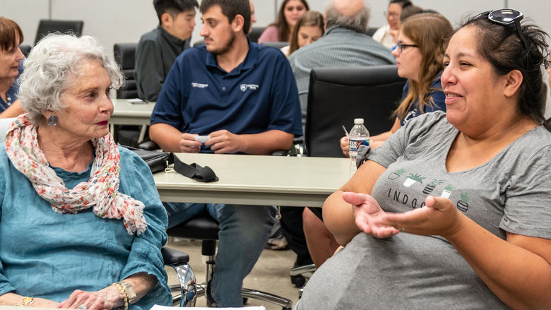 A multi-generational conversation between two people at an OLLI event