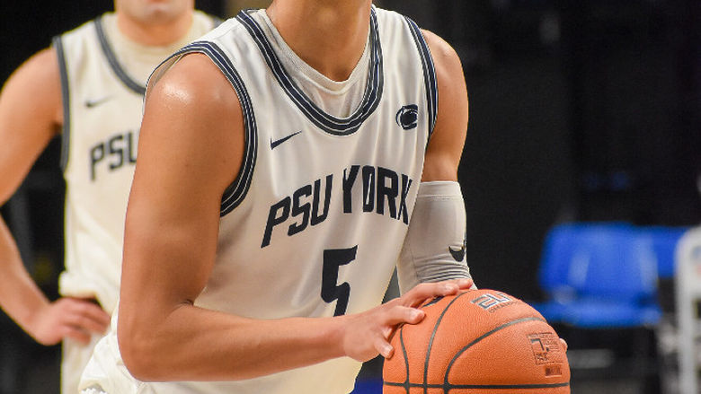Basketball player getting ready to take a foul shot.