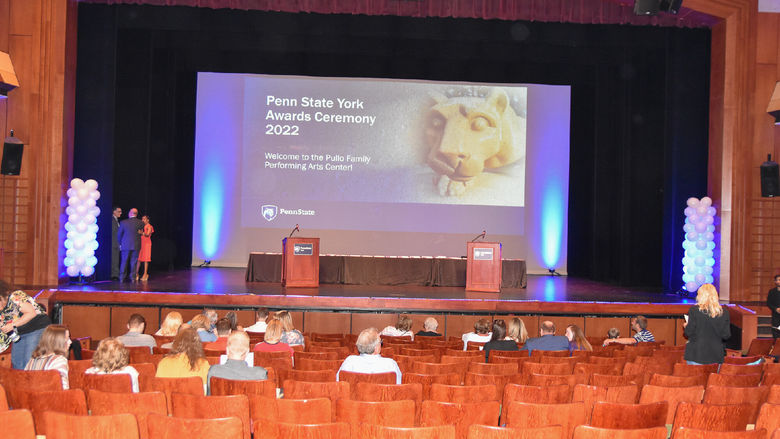 Theatre stage with podiums and balloons.