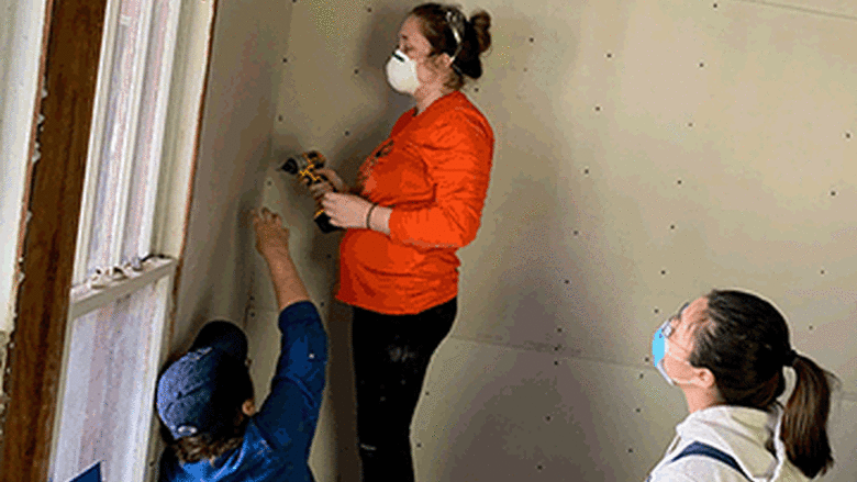 Students hang drywall