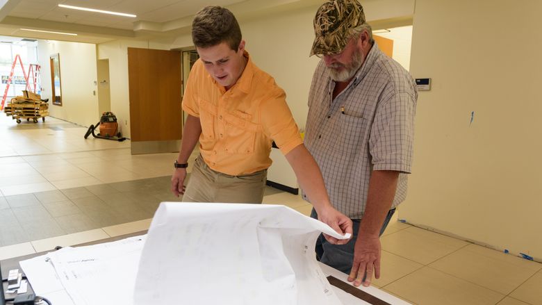 Luke Marsiglia with job site supervisor