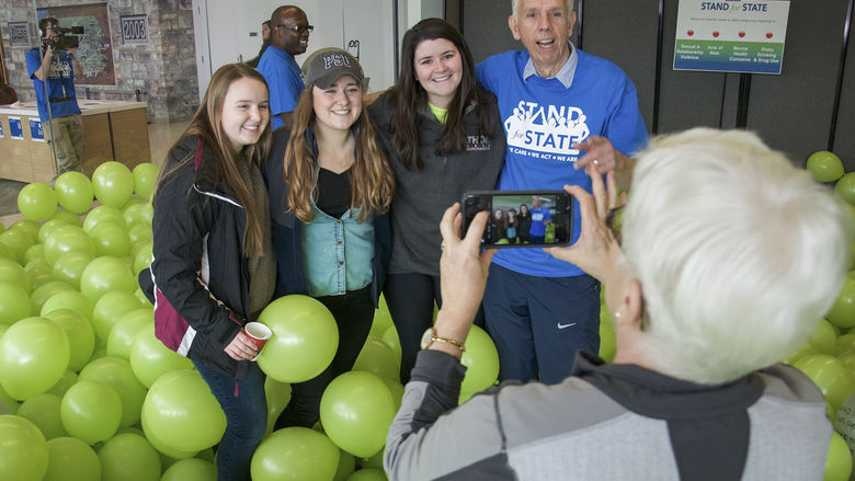 Mike the Mailman posing with students