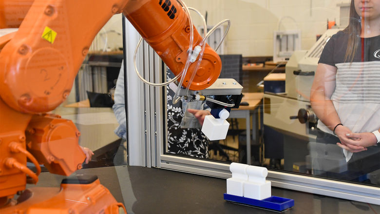 Students performing a demo with the A.B.B. robotic arm found in the Swenson Engineering Center.