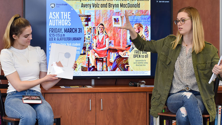 Two student authors, Avery Volz and Brynn MacDonald, presenting their latest work to the campus community.