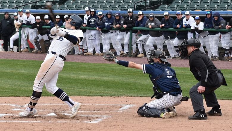 Baseball player swinging a bat.