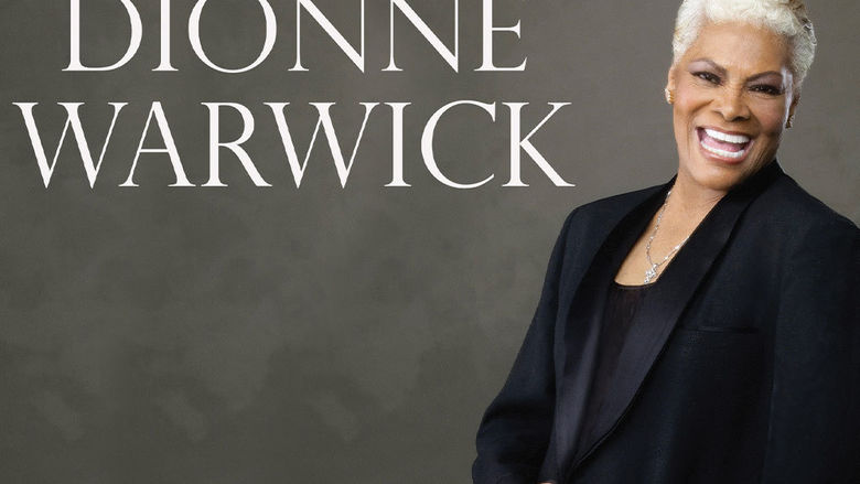 "Dionne Warwick" Woman wearing a black blazer, smiling confidently at the camera.