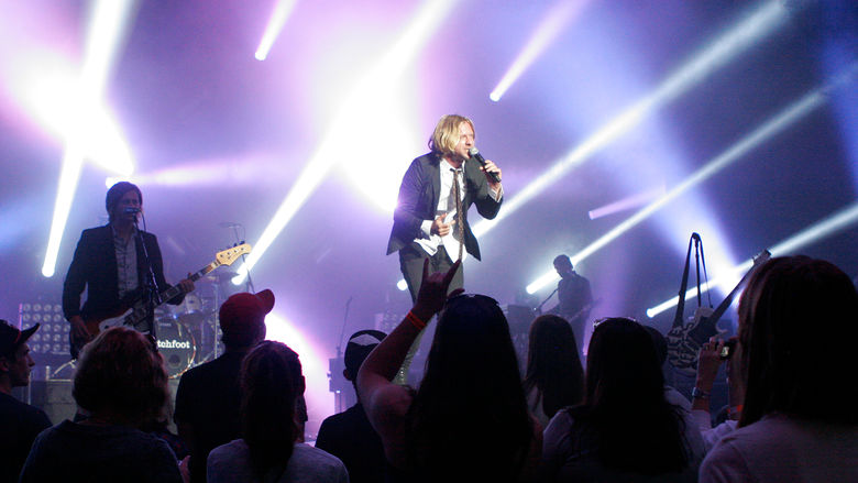 A musician singing on the stage of the Pullo Center