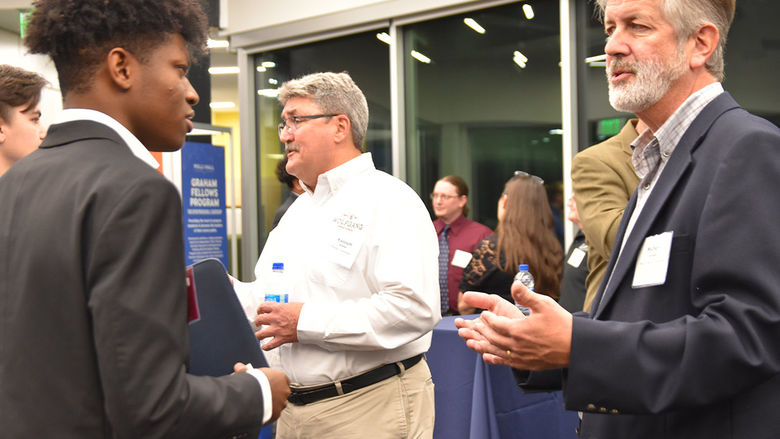 A Graham candidate conversing with a Corporate Partner of the Graham Fellows Program during an annual networking event.