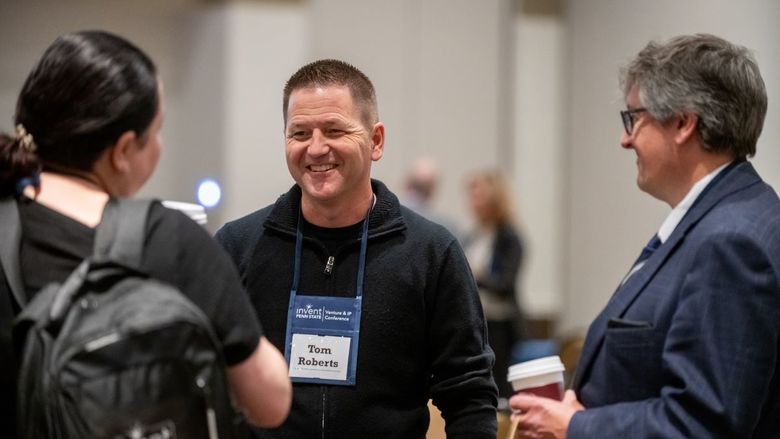 Three attendees network at the conference