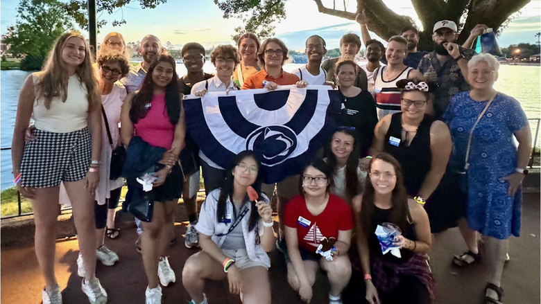 group of people standing with flag