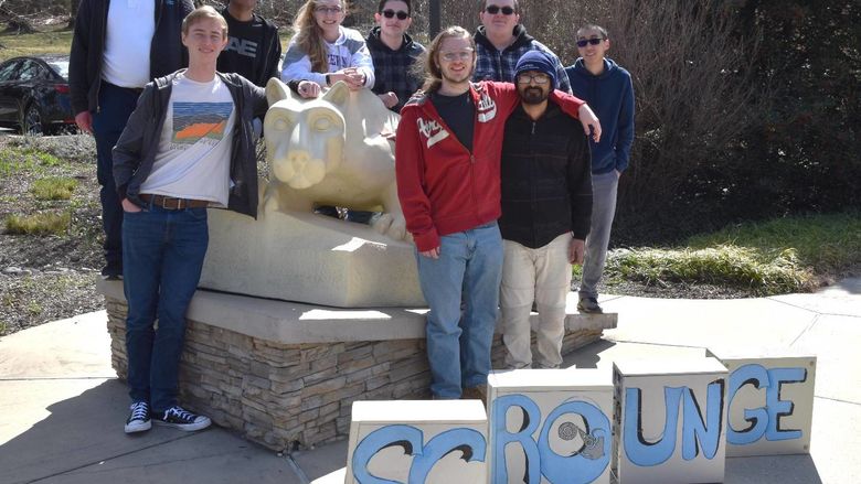 Students standing around the lion shrine. 