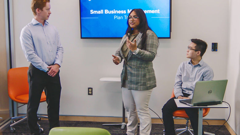Three students giving a Small Business Management presentation.