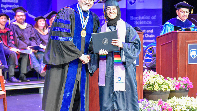 Student receiving her diploma from Chancellor Christiansen.